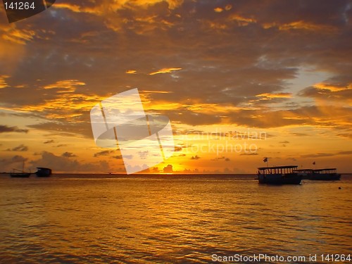 Image of boats in sunset