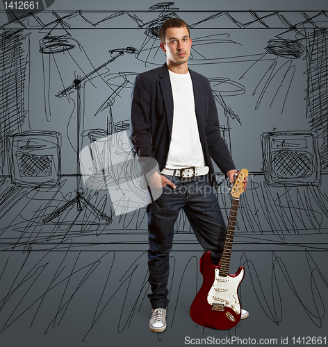 Image of stylish man with guitar looking at camera