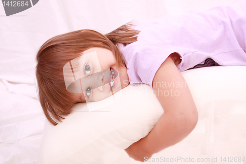 Image of Beautiful little girl lying on bed 