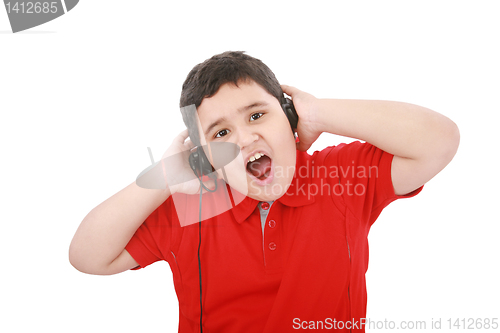 Image of Portrait of a sweet young boy listening to music on headphones a