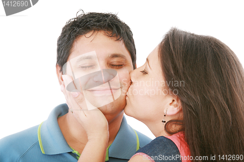 Image of Nice girl kisses the young modest guy on a cheek 