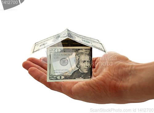 Image of hand holding cash house