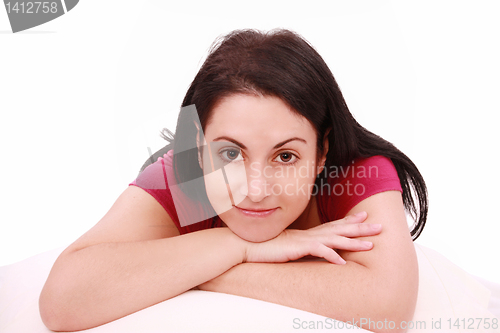 Image of Beautiful young brunette woman lying on the bed