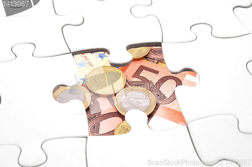 Image of puzzle and money