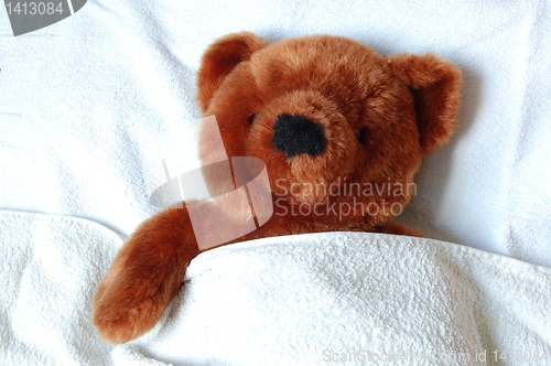 Image of sick teddy with injury in bed