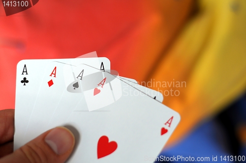 Image of hand holding four aces