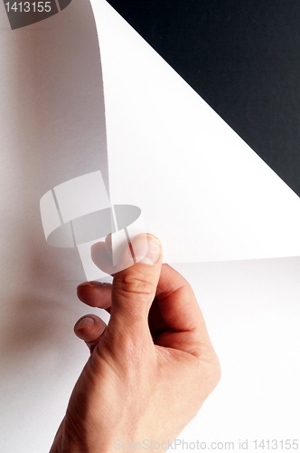 Image of hand turning paper