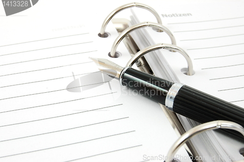 Image of business organizer and pen