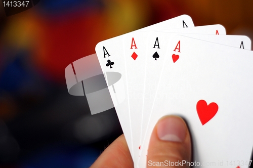 Image of hand holding four aces