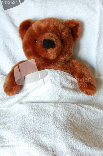 Image of sick teddy with injury in bed