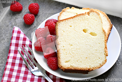 Image of Two sliced fresh pound cake with raspberries. Selective focus on