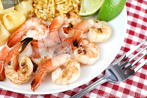 Image of Barbecued Shrimp with pineapple, rice and lime.  Selective focus