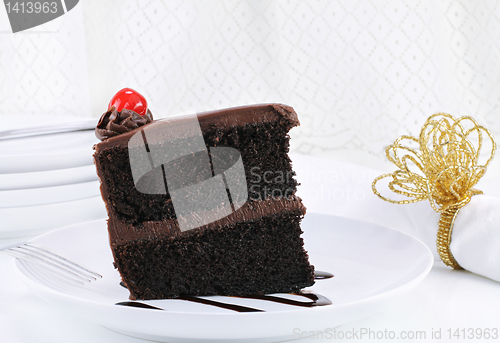 Image of Chocolate Fudge Cake with Cherry in Elegant Table Setting