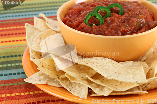 Image of Salsa, jalapeno pepper slices and tortilla chips