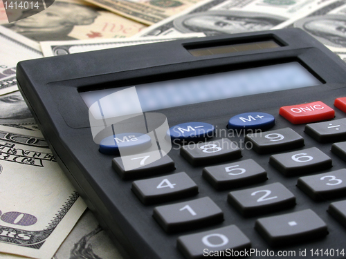 Image of calculator on cash