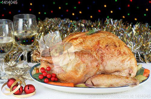 Image of Whole Roasted, Stuffed Turkey in an Evening Christmas Setting