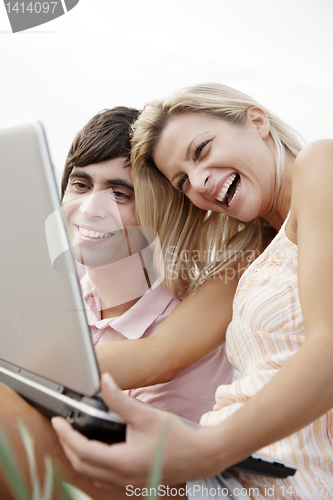 Image of happy couple with laptop