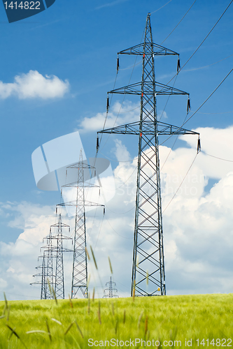 Image of high voltage power lines against a blue sky