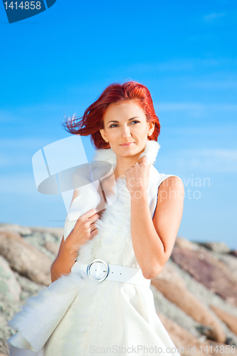 Image of  beautiful woman  in white on seacoast