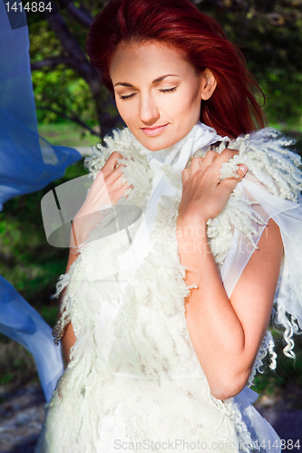 Image of beautiful woman in white in sun beam