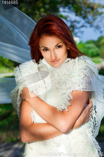 Image of beautiful woman in white in a park