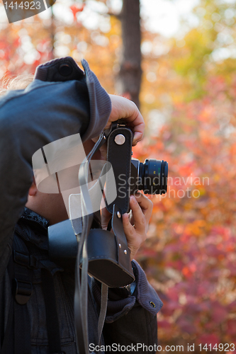 Image of Man making photo with old-fashioned camera