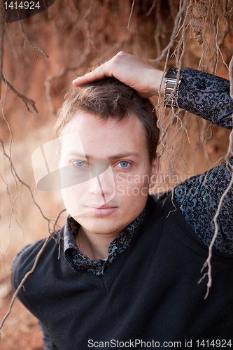 Image of Portrait of a man with tree root on background