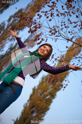 Image of Young girl with raised arms