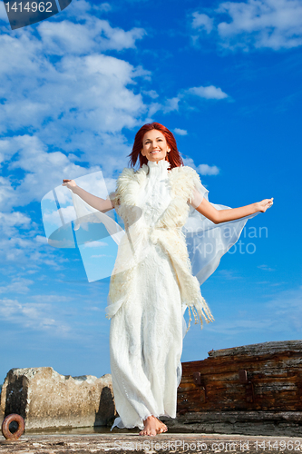 Image of  beautiful woman  in white on seacoast