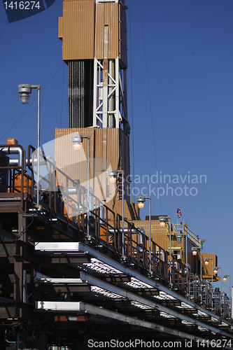 Image of production line and drilling rig derrick