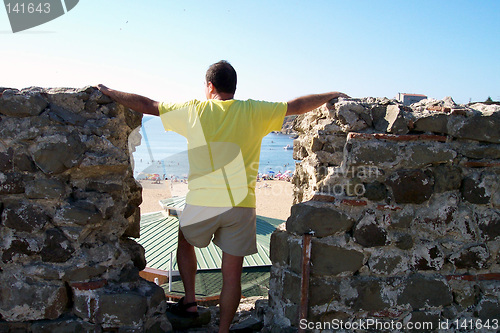 Image of man watching sea