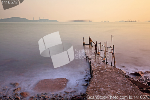 Image of Jetty on sea at sunset