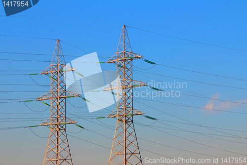 Image of electric power transmission towers at sunrise