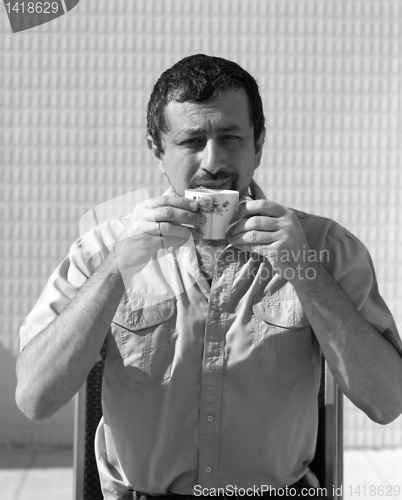 Image of business man at morning drinks coffee