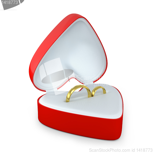 Image of Pair of wedding rings in a heart shaped box