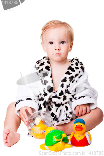 Image of baby boy playing with  toys after bathing