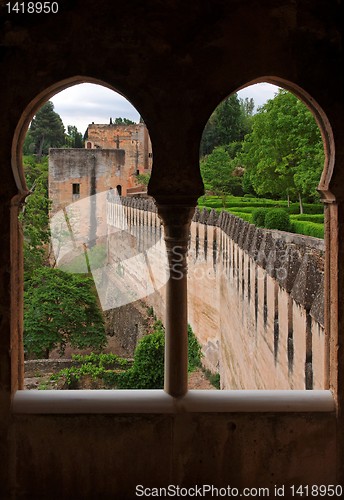 Image of Medieval bastions seen through the castle window in Alhambra 