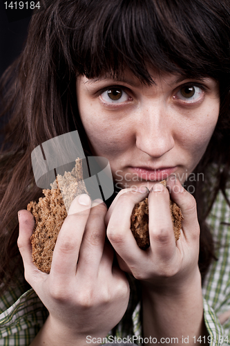 Image of poor beggar woman with a piece of bread