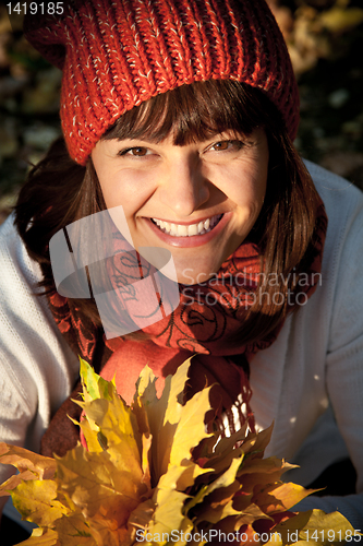 Image of woman with autumn leaves