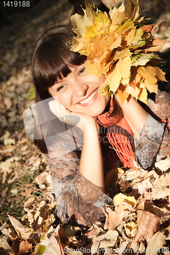 Image of woman with autumn leaves