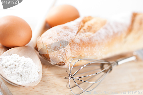 Image of  bread, flour, eggs and kitchen utensil 