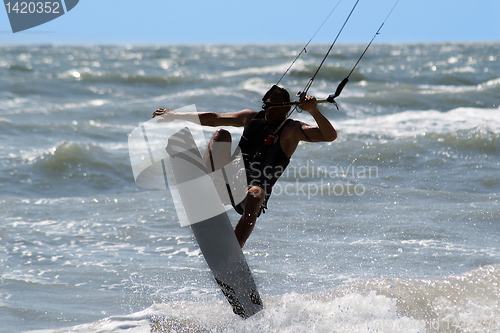 Image of Kite surfer jumping and flying high