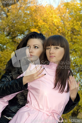 Image of Two beauty young women outdoors in the autumn