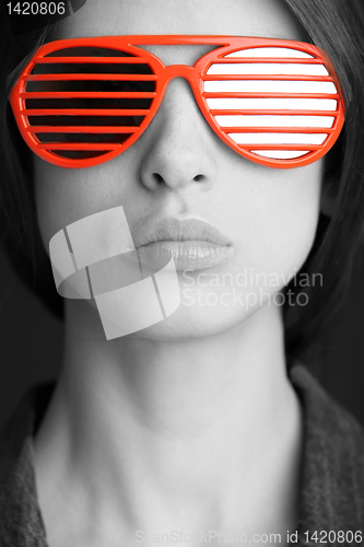 Image of red sunglasses on the face