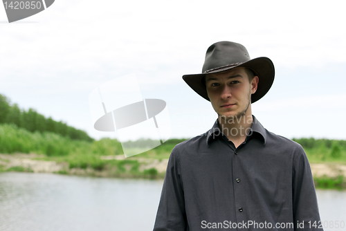 Image of man in a cowboy hat standing 