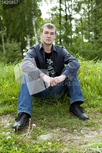 Image of man sitting in the woods