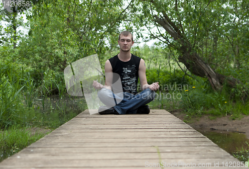 Image of man sitting in the lotus position and meditates