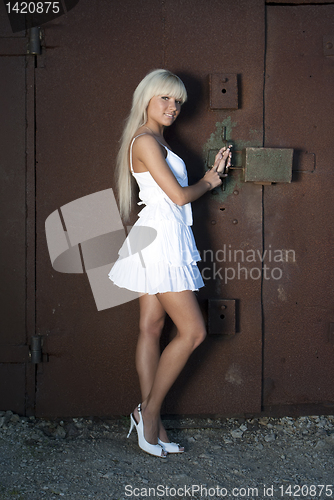 Image of girl opens old garage