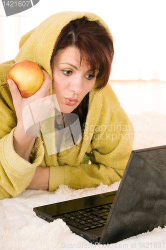 Image of woman with laptop and apple