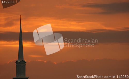 Image of Church steeple set against sunset